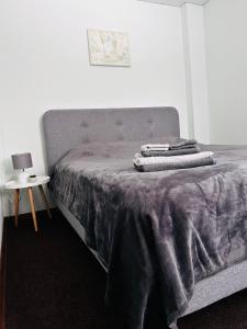 a bed with a purple blanket on top of it at Книжка in Vinnytsya