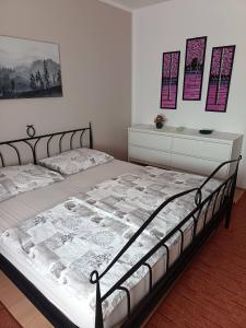 a bedroom with a bed and a dresser at Vila Josipa in Vukovar