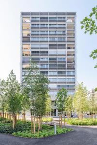 a tall building with trees in front of it at CITY STAY - Papieri-Ring in Cham