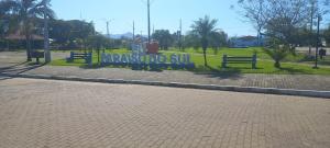 a park with benches with a sign that reads rascored sub at Pousada Germânia Paraíso do Sul in Paraíso do Sul +1 photo