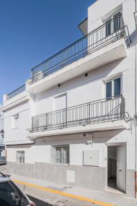 a white apartment building with a balcony at Algaba Huelva alto in La Algaba
