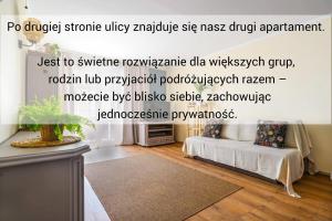 a living room with a couch and a table at Apartament Dana in Kołobrzeg