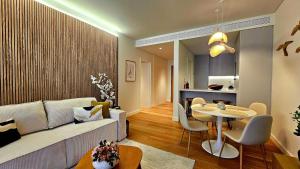 a living room with a couch and a table at Sweet Horizon in Quarteira