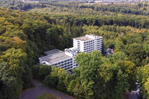 an aerial view of a building in the forest at Fletcher Hotel-Restaurant Arnsberg-Sauerland in Arnsberg