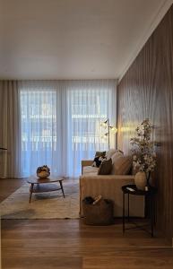 a living room with a couch and a table at Sweet Horizon in Quarteira +40 photos
