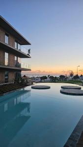 a large swimming pool in front of a building at Sweet Horizon in Quarteira