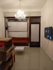 a living room with a chandelier and a room with a door at Studio Appartement without steps and terrace in Görlitz