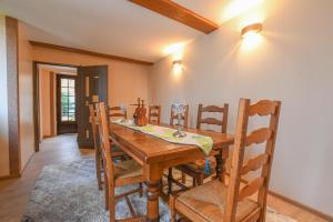 a dining room with a wooden table and chairs at La lukas in Mussy-sur-Seine