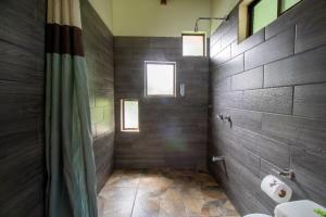 a bathroom with a shower and a toilet in it at Coffee House in Monteverde Costa Rica