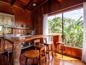 a kitchen with a large wooden counter and a large window at Coffee House in Monteverde Costa Rica