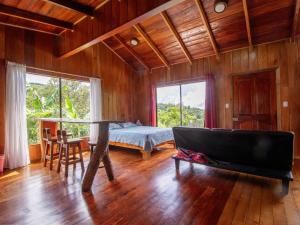 a bedroom with a bed and a table and chairs at Coffee House in Monteverde Costa Rica +53 photos