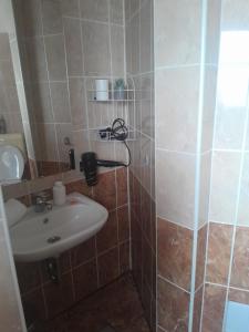 a bathroom with a sink and a shower at Holiday Apartman in Bük +31 photos