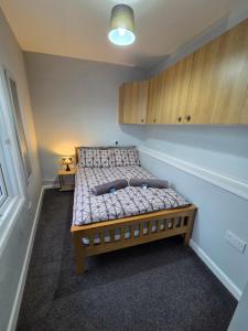 a small bedroom with a bed in the corner at 1B Smart Apartments in Newark-on-Trent
