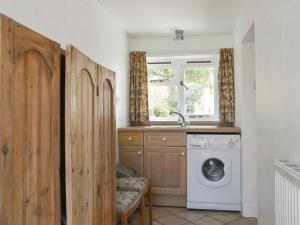 a laundry room with a washing machine and a window at Upper Broughton Farm Cottage in Snead +15 photos