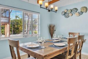a dining room with a wooden table and chairs at Island Gem A home in Anna Maria +27 photos