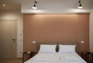 a bedroom with a bed with two white pillows at VenereCiprea in Castelbuono
