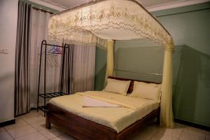 a bedroom with a bed with a canopy at JD LUXURY HOTEL Jinja in Jinja +38 photos