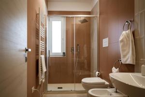 a bathroom with a shower and a toilet and a sink at VenereCiprea in Castelbuono +25 photos
