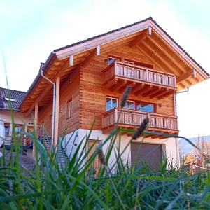 a wooden house with balconies on it at Bauernhofurlaub Eggcellence in Teisendorf
