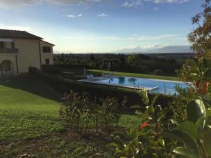 a house with a swimming pool in a yard at Il Borgherino in Cerreto Guidi