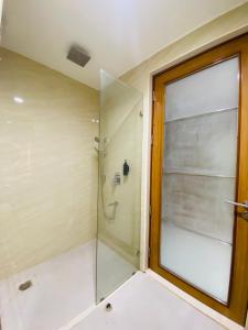 a shower with a glass door in a bathroom at The Manak Bagh in Sehore +8 photos