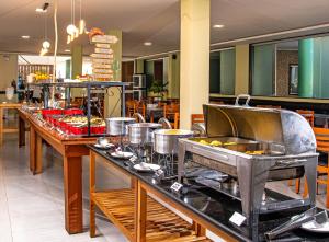 a buffet line with many pots and pans at Porto Mar Hotel in Porto Seguro