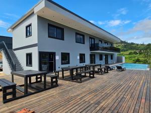 a building with benches on a wooden deck at Pegasus Peak Lodge in Drummond