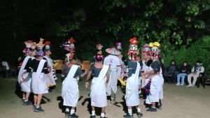 a group of people dressed in white performing a dance at Rapti Resort in Jhawāni