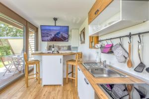 a tiny kitchen with a sink and a counter top at Riverside Suite Mobile Homes in Gradac