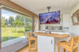 a home office with a sink and a large window at Riverside Suite Mobile Homes in Gradac