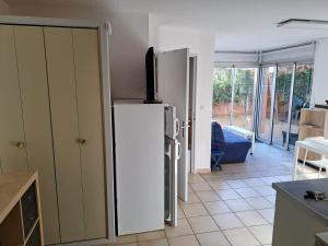 a kitchen with a refrigerator with a television on top at Joli t2 valras plage in Valras-Plage