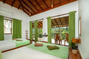 two beds in a room with green curtains at Evergreen Villa - Sinharaja in Deniyaya
