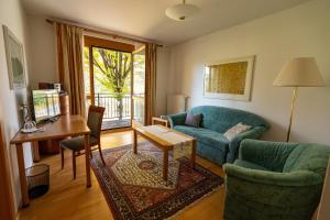 a living room with a couch and a table at Pension Christina in Weiz
