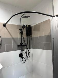 a shower in a bathroom with a shower at Atrium Kathu Hotel in Ban Kathu (1) +15 photos