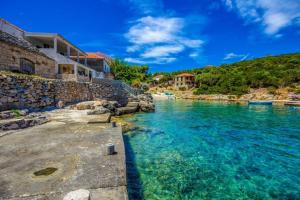 a view of a river with houses on the shore at Apartmány Viktor in Selca kod Bogomolja