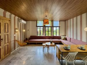 a living room with a couch and a table at Beit El Berbara-Pool & Breakfast in Al Ḩulwah +252 photos