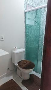 a bathroom with a toilet with a glass shower at Casa Itanhaém Praia Cibratel in Itanhaém +16 photos