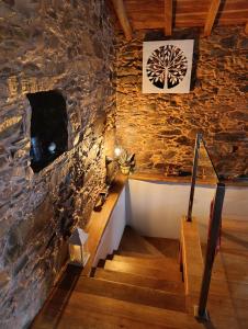 a stone wall with a staircase in a house at Casinha do Talasnal in Lousã