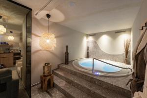 a bathroom with a bath tub in a room at Residence Angelika in Corvara in Badia +53 photos