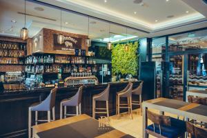 a bar in a restaurant with chairs and tables at Hotel Royal & Spa in Białystok