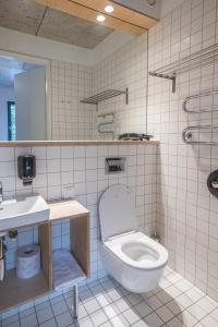 a bathroom with a toilet and a sink at Melt in Palanga Self check-in in Palanga