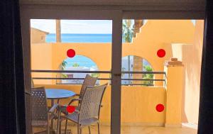 a view of a patio with a table and chairs at Casinomar Apartments Pool, Garden & Private Terrace in Benalmádena