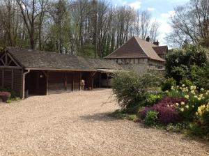 a house with a gravel driveway in front of a garden at La Forge de Paul et Virginie in Mainneville