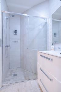 a white bathroom with a shower and a sink at ABC Apartments Madrid in Madrid