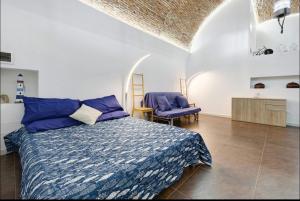 a bedroom with a bed and a table and chairs at Seafront, Large Studio on the Beach with AC and WiFi in Pietra Ligure