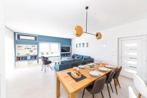 a living room with a table and a blue couch at Villa Olivia Trogir in Trogir