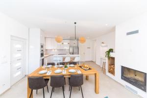 a dining room with a table and chairs and a fireplace at Villa Olivia Trogir in Trogir