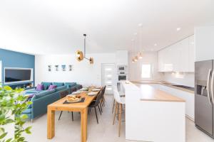 a kitchen and living room with a table and a couch at Villa Olivia Trogir in Trogir +49 photos