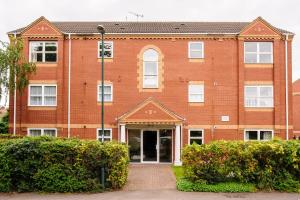 a large red brick building with a door at Beaumont Court in Coventry