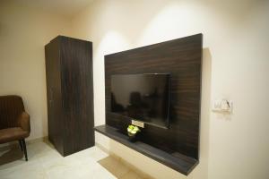 a large flat screen tv on a wall at The Leaf Farm in Ludhiana